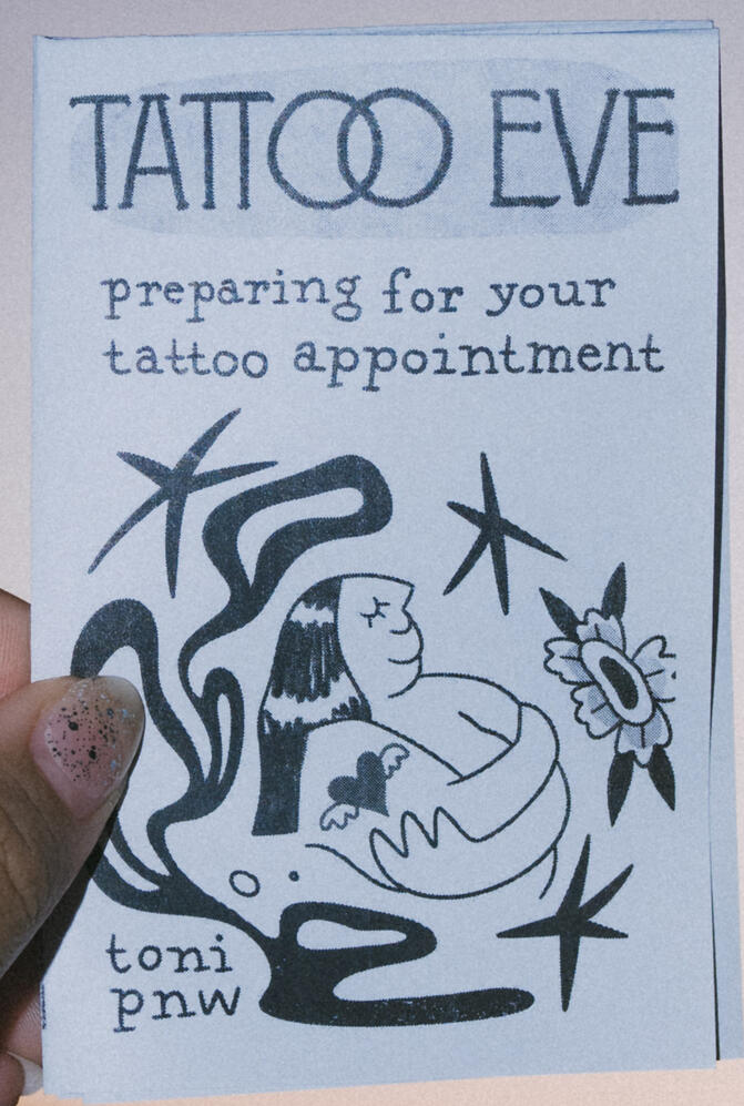 A photo of a zine cover depicting the upper bust of a person hugging their own body. The person is circled by stars, flowers, and squiggles. Above reads, "Tattoo Eve Preparing for your tattoo appointment." This zine is titled "Tattoo Eve"