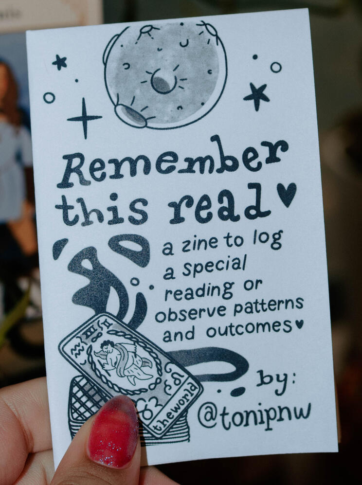 Untitled A photo of a zine titled "Remember this read. A zine to log a special reading or observe patterns and outcomes." A drawn image of the moon is at the top and a tarot deck is at the bottom.